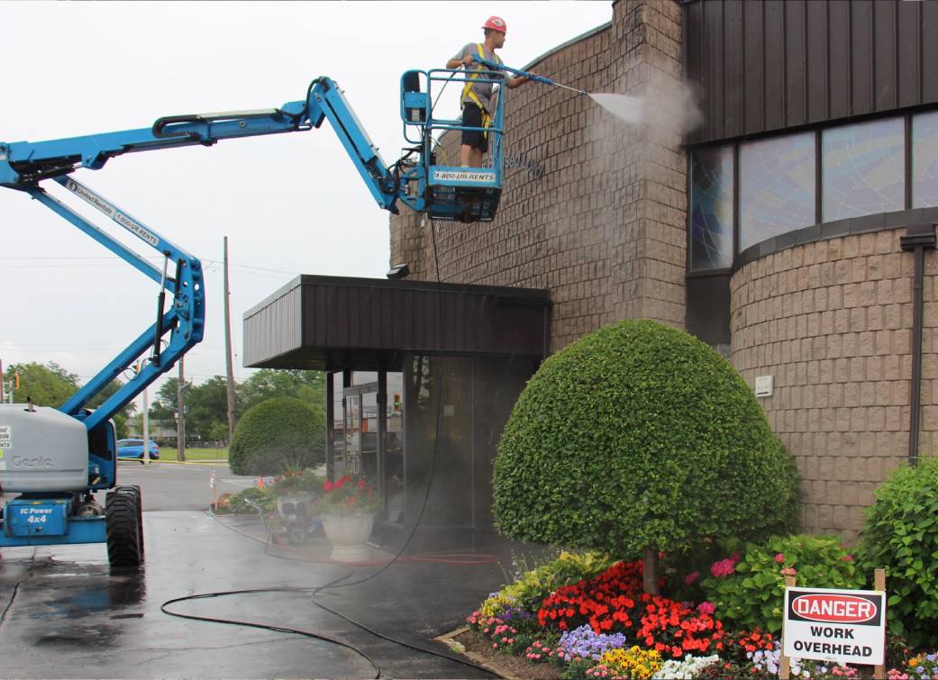 A.D.S. Expert, cleaning exterior of a commercial building.